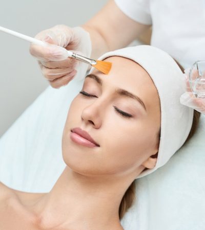 Cosmetology beauty procedure. Young woman skin care.